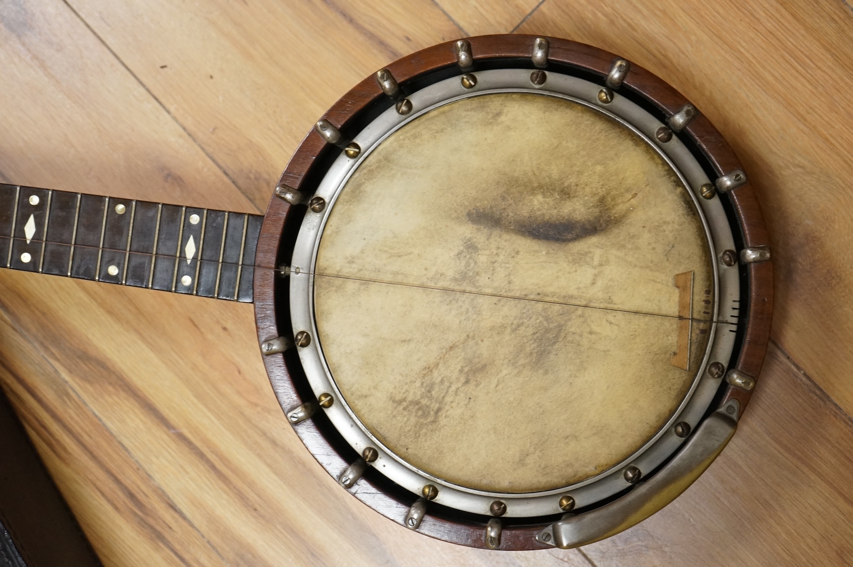 A rosewood banjo with mother of pearl inlay, cased